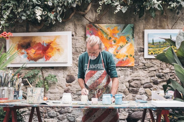 Painter: Artist busy on his creative work Painter: Artist busy on his creative work